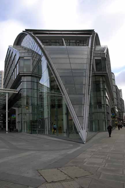 A building entrance shaped as a crow beak - steel-glass building in London, JBLArts photography