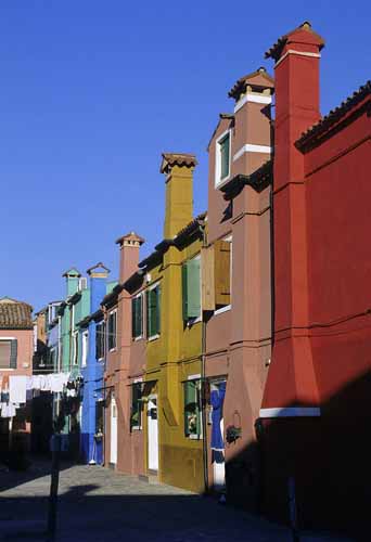 A foreshortened view of Burano's coloured terrace houses with chimneys - Burano in Venice, JBLArts photography