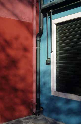 The corner of a closed court with coloured drainpipes twin-set with the walls - Burano in Venice, JBLArts photography