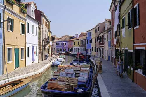 A foreshortened view of a Burano's canal with its coloured houses and a greengrocer boat - Burano in Venice, JBLArts photography