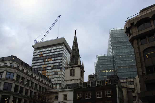 An old bell-tower surrounded by modern skyscraper - steel-glass building in London, JBLArts photography